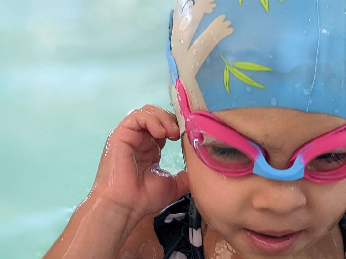 child swimming at the pool